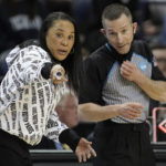 
              FILE - South Carolina head coach Dawn Staley speaks with an official during the first half of a college basketball game against Creighton in the Elite 8 round of the NCAA tournament in Greensboro, N.C., Sunday, March 27, 2022. Staley said referees on the men's side should be “stepping up” and advocating for equal pay for women's referees. “They don't do anything different," she said. “Why should our officials get paid less for taking the (expletive) we give them?" (AP Photo/Gerry Broome, File)
            