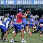 
              New York Giants quarterback Daniel Jones (8) runs a play during training camp at the NFL football team's practice facility, Saturday, July 30, 2022, in East Rutherford, N.J. (AP Photo/John Minchillo)
            