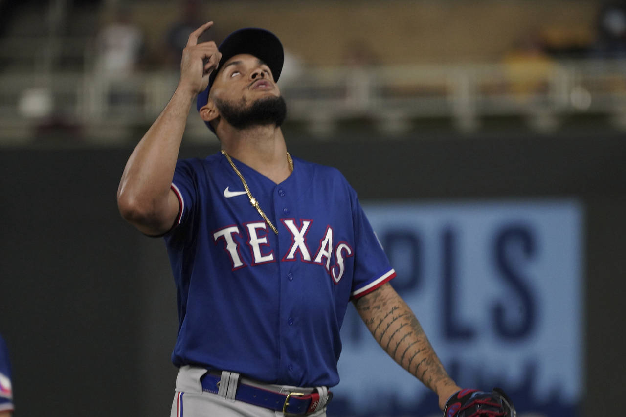 Texas Rangers relief pitcher Jonathan Hernandez celebrates the final out against the Minnesota Twin...