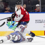 
              United States' Matt Knies (89) is checked by Austria's Finn van Ee (15) during the first period of an IIHF World Junior Hockey Championship game in Edmonton, Alberta, Saturday, Aug. 13, 2022. (Jason Franson/The Canadian Press via AP)
            