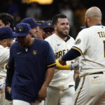 
              Milwaukee Brewers' Victor Caratini, second from right, is congratulated by teammates after his two-run single during the 11th inning of the team's baseball game against the Los Angeles Dodgers on Tuesday, Aug. 16, 2022, in Milwaukee. The Brewers won 5-4. (AP Photo/Aaron Gash)
            