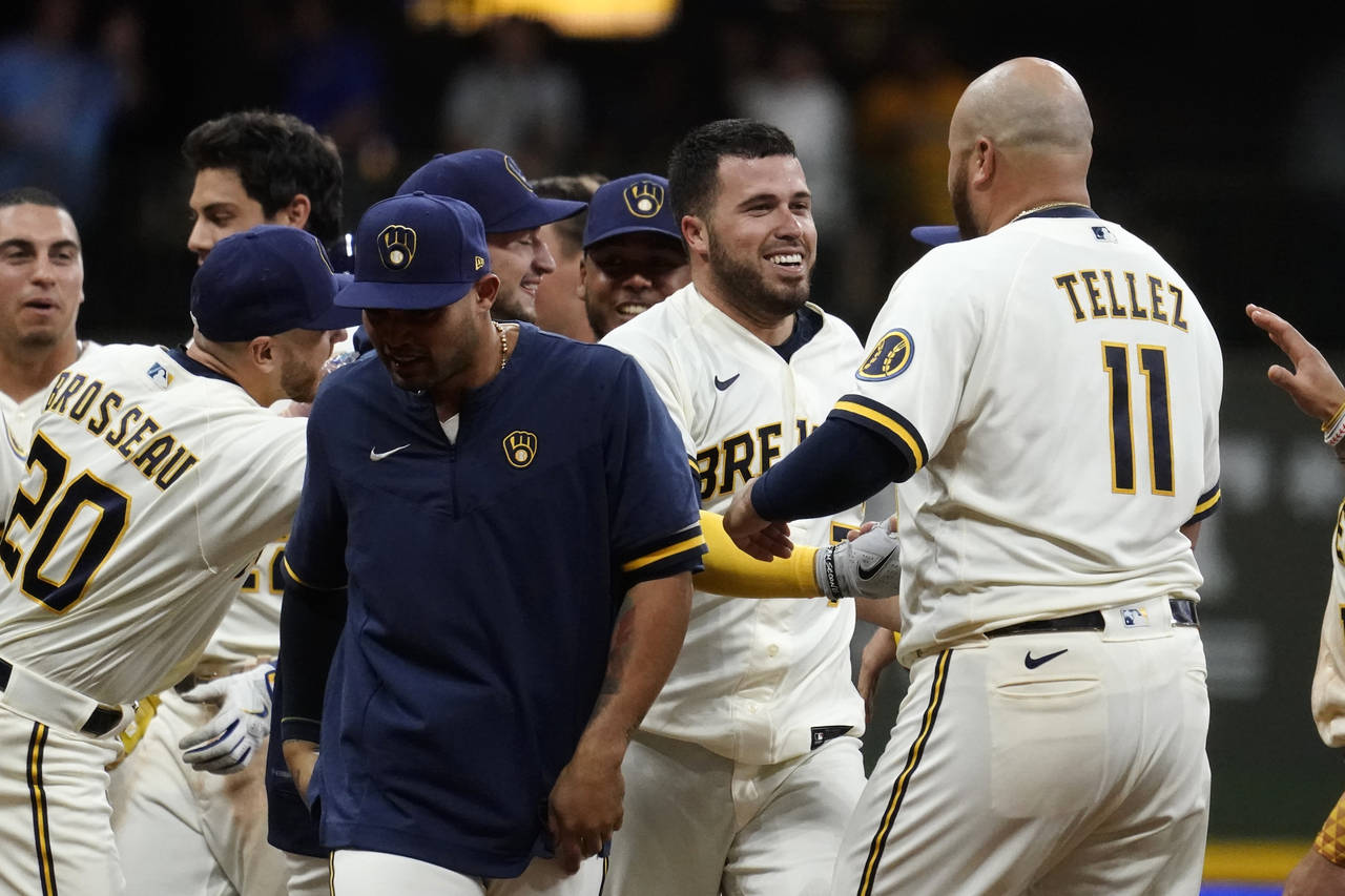 Milwaukee Brewers' Victor Caratini, second from right, is congratulated by teammates after his two-...
