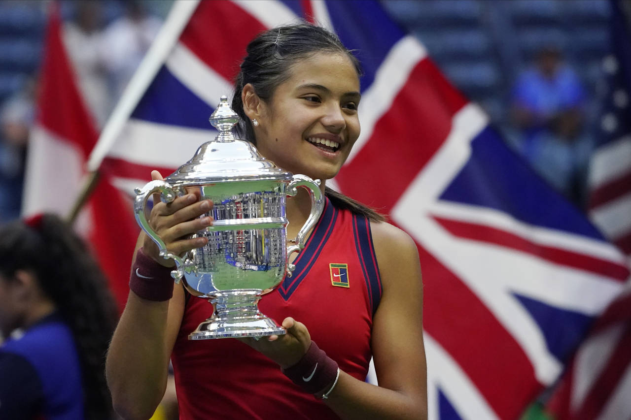 FILE - Emma Raducanu, of Britain, holds up the U.S. Open championship trophy after defeating Leylah...