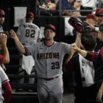
              Arizona Diamondbacks starting pitcher Merrill Kelly (29) is greeted in the dugout after leaving a baseball game against the Chicago White Sox during the eighth inning Saturday, Aug. 27, 2022, in Chicago. (AP Photo/David Banks)
            