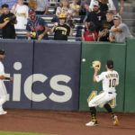 
              Pittsburgh Pirates center fielder Bryan Reynolds (10) and left fielder Tucupita Marcano (30) field a fly ball by Atlanta Braves' Michael Harris II that hit the wall and went for a double during the fifth inning of a baseball game, Tuesday, Aug. 23, 2022, in Pittsburgh. (AP Photo/Keith Srakocic)
            