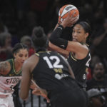 
              Las Vegas Aces forward A'ja Wilson, right, looks to pass to uard Chelsea Gray (12) to pass during the first half of a WNBA basketball game against the Seattle Storm, Sunday, Aug. 14, 2022, in Las Vegas. (AP Photo/Sam Morris)
            