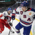 
              United States' Matt Knies (89) and Czechia's Michal Gut (26) battle for the puck during the second period in a quarterfinal in the IIHF junior world hockey championships Wednesday, Aug. 17, 2022, in Edmonton, Alberta. (Jason Franson/The Canadian Press via AP)
            