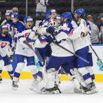 
              Slovakia players celebrate after a shootout win over Latvia during an IIHF junior world hockey championships game Friday, Aug. 12, 2022, in Edmonton, Alberta. (Jason Franson/The Canadian Press via AP)
            