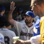
              Seattle Mariners starting pitcher Robbie Ray celebrates in the dugout during the seventh inning of a baseball game against the Cleveland Guardians, Sunday, Aug. 28, 2022, in Seattle. (AP Photo/Stephen Brashear)
            