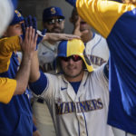 
              Seattle Mariners' Ty France is congratulated by teammates in the dugout after hitting a solo home run off Cleveland Guardians starting pitcher Aaron Civale during the seventh inning of a baseball game, Sunday, Aug. 28, 2022, in Seattle. (AP Photo/Stephen Brashear)
            
