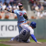 
              Minnesota Twins infielder Luis Arraez throws to first for a double play after forcing out Kansas City Royals' Vinnie Pasquantino during the fourth inning of a baseball game Wednesday, Aug. 17, 2022, in Minneapolis. (AP Photo/Abbie Parr)
            