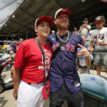 
              Boston Red Sox's Alex Verdugo, center right, poses with a member of the Little League Team from Matamoros, Mexico, during a visit to the Little League World Series in South Williamsport, Pa., Sunday, Aug. 21, 2022. The Red Sox iplay the Baltimore Orioles in the Little League Classic on Sunday Night Baseball. (AP Photo/Gene J. Puskar)
            