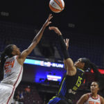 
              Dallas Wings guard Allisha Gray (15) shoots over Connecticut Sun forward DeWanna Bonner (24) during Game 1 of a WNBA basketball first-round playoff series Thursday, Aug. 18, 2022, in Uncasville, Conn. (Sean D. Elliot/The Day via AP)
            