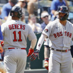 
              Boston Red Sox' Rafael Devers (11) is congratulated at home plate by Xander Bogaerts, right, after hitting a home run during the sixth inning of a baseball game in Kansas City, Mo., Sunday, Aug. 7, 2022. (AP Photo/Colin E. Braley)
            