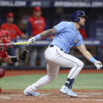 
              Tampa Bay Rays' David Peralta singles in the game-winning run in front of Los Angeles Angels catcher Max Stassi during the 11th inning of a baseball game Wednesday, Aug. 24, 2022, in St. Petersburg, Fla. The Rays won 4-3. (AP Photo/Mike Carlson)
            
