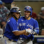 
              Toronto Blue Jays' Vladimir Guerrero, left, celebrates his three-run home run against the Minnesota Twins with George Springer during the eighth inning of a baseball game Thursday, Aug. 4, 2022, in Minneapolis. (AP Photo/Bruce Kluckhohn)
            