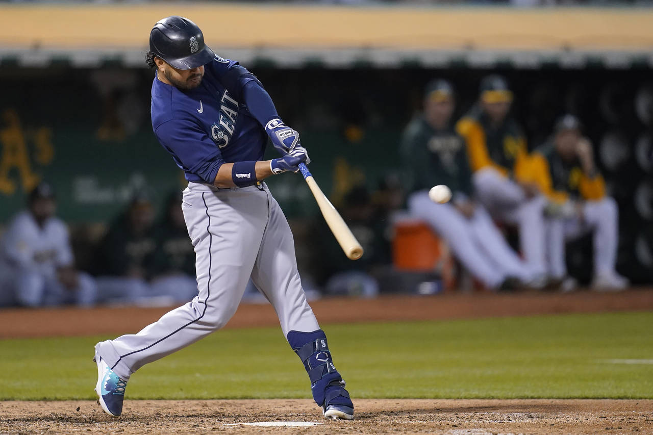 Seattle Mariners' Eugenio Suarez hits a three-run home run against the Oakland Athletics during the...