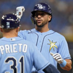 
              Tampa Bay Rays' David Peralta celebrates with first base coach Chris Prieto (31) after his single off Los Angeles Angels starting pitcher Tucker Davidson during the fourth inning of a baseball game Monday, Aug. 22, 2022, in St. Petersburg, Fla. (AP Photo/Chris O'Meara)
            