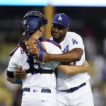 
              Los Angeles Dodgers catcher Austin Barnes (15) and relief pitcher Hanser Alberto (17) hug after a 12-6 win over the Milwaukee Brewers in a baseball game in Los Angeles, Wednesday, Aug. 24, 2022. (AP Photo/Ashley Landis)
            