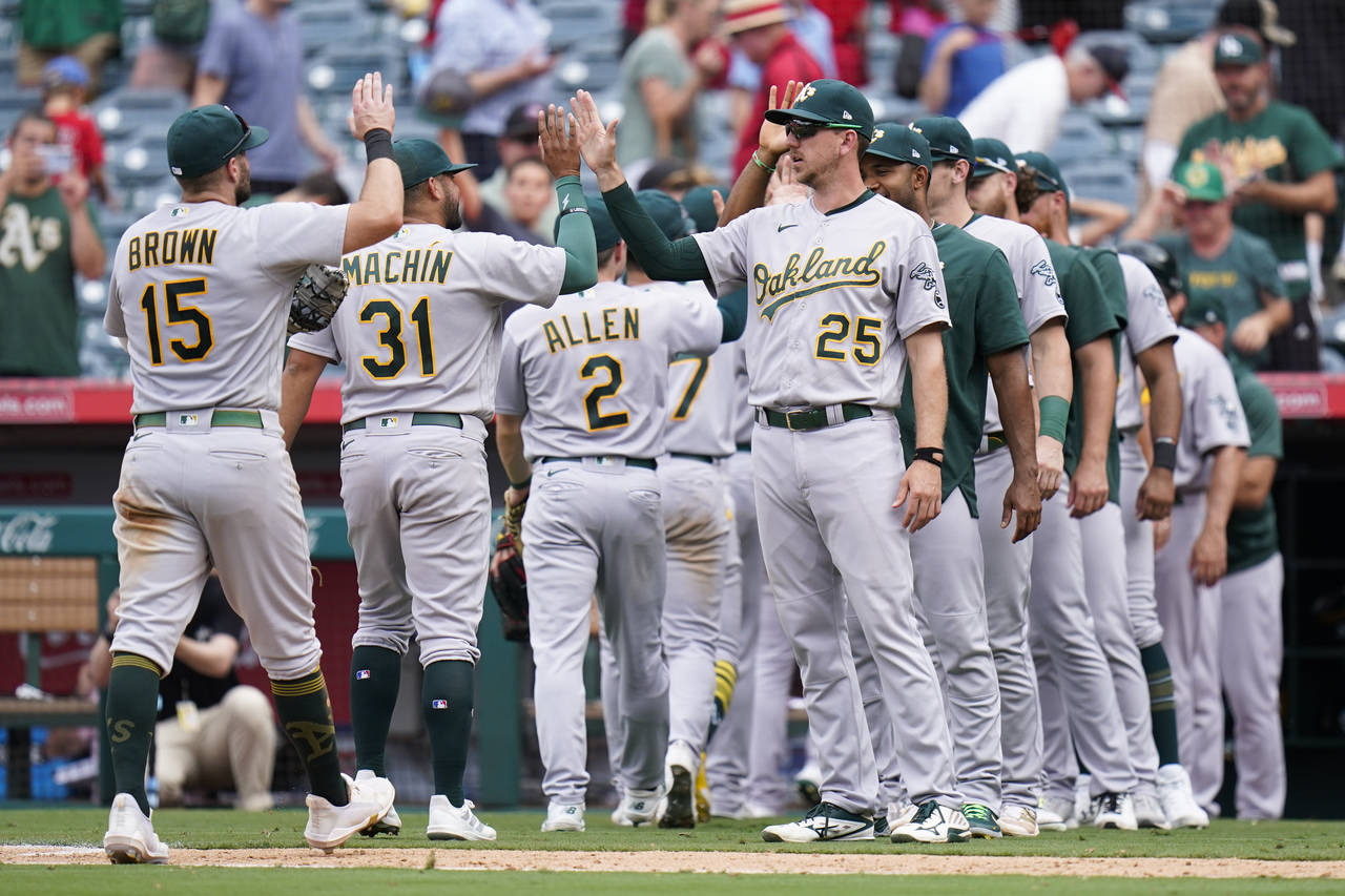 Oakland Athletics players celebrate the team's 8-7 win in a baseball game against the Los Angeles A...