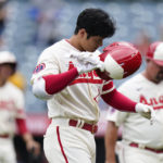 
              Los Angeles Angels' Shohei Ohtani takes off his helmet after he popped out to end the baseball game against the Oakland Athletics on Thursday, Aug. 4, 2022, in Anaheim, Calif. The Athletics won 8-7. (AP Photo/Jae C. Hong)
            