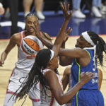 
              Minnesota Lynx center Sylvia Fowles, right, loses the ball under pressure from Connecticut Sun forward Jonquel Jones, front left, during a WNBA basketball game Sunday, Aug. 14, 2022, in Uncasville, Conn. (Sean D. Elliot/The Day via AP)
            