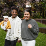 
              Ellia Green with his partner Vanessa Turnbull-Roberts and their daughter Waitui pose in Sydney, Australia, Monday, Aug. 15, 2022. Green, one of the stars of Australia's gold medal-winning women's rugby sevens team at the 2016 Olympics, has transitioned to male. The 29-year-old, Fiji-born Green is going public in a video at an international summit aimed at ending transphobia and homophobia in sport. The summit is being hosted in Ottawa as part of the Bingham Cup rugby tournament. (AP Photo/Mark Baker)
            
