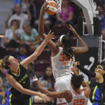 
              Connecticut Sun forward Jonquel Jones pulls down a rebound over Dallas Wings guard Marina Mabrey and guard Allisha Gray  and teammates Alyssa Thomas (25) in Game 2 of a WNBA basketball first-round playoff series, Sunday, Aug. 21, 2022, in Uncasville, Conn. (Sean D. Elliot/The Day via AP)
            