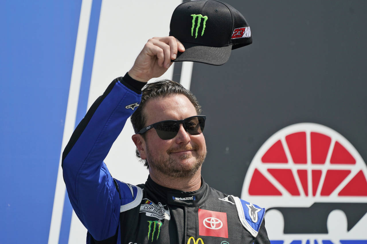 FILE - NASCAR Cup Series driver Kurt Busch tips his cap prior to the NASCAR Cup Series auto race at...