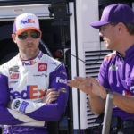 
              Denny Hamlin, left, talks to a crew member prior to practice and qualifying at Richmond Raceway for Sunday's NASCAR Cup Series auto race Saturday, Aug. 13, 2022, in Richmond, Va. (AP Photo/Steve Helber)
            