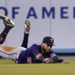
              Minnesota Twins center fielder Gilberto Celestino loses the ball after initially making a catch off the bounce on a ball hit by Los Angeles Dodgers' Trea Turner during the second inning of a baseball game Tuesday, Aug. 9, 2022, in Los Angeles. Turner had RBI double on the play .(AP Photo/Mark J. Terrill)
            