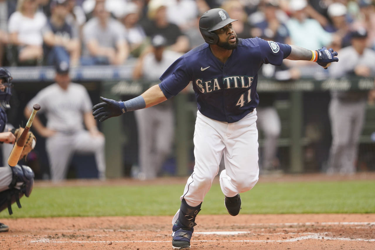 Seattle Mariners' Carlos Santana tosses his bat after hitting a two-run home run against the New Yo...