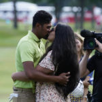 
              Tony Finau kisses his wife Alayna on the 18th green after winning the Rocket Mortgage Classic golf tournament, Sunday, July 31, 2022, in Detroit. (AP Photo/Carlos Osorio)
            