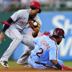 
              Philadelphia Phillies' Jean Segura, right, tries to steal second base past Cincinnati Reds shortstop Jose Barrero during the fourth inning of a baseball game, Thursday, Aug. 25, 2022, in Philadelphia. Segura was tagged out on the attempt. (AP Photo/Matt Slocum)
            