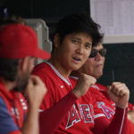 
              Los Angeles Angels' Shohei Ohtani plays around with a teammate in the dugout in the fifth inning of a baseball game against the Detroit Tigers in Detroit, Saturday, Aug. 20, 2022. (AP Photo/Paul Sancya)
            