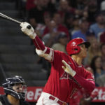 
              Los Angeles Angels' Shohei Ohtani, right, hits a two-run home run as New York Yankees catcher Jose Trevino watches during the fifth inning of a baseball game Monday, Aug. 29, 2022, in Anaheim, Calif. (AP Photo/Mark J. Terrill)
            