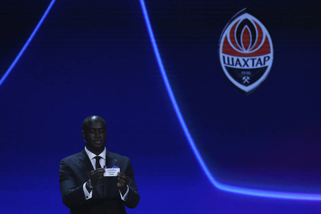 Ivorian coach and former player Yaya Toure shows the name of FC Shakhtar Donetsk during the soccer ...