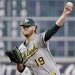 
              Oakland Athletics starting pitcher Cole Irvin (19) throws against the Houston Astros during the first inning of a baseball game Sunday, Aug. 14, 2022, in Houston. (AP Photo/Michael Wyke)
            