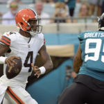 
              Cleveland Browns quarterback Deshaun Watson (4) looks for a receiver as he is pressured by Jacksonville Jaguars defensive end Roy Robertson-Harris (95) during the first half of an NFL preseason football game, Friday, Aug. 12, 2022, in Jacksonville, Fla. (AP Photo/Phelan M. Ebenhack)
            