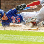 
              New York Mets' Pete Alonso beats the tag by Cincinnati Reds catcher Michael Papierski (26) to score during the seventh inning of a baseball game against the Cincinnati Reds, Wednesday, Aug. 10, 2022, in New York. (AP Photo/Julia Nikhinson)
            