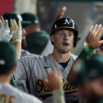 
              Oakland Athletics' Sean Murphy, center, is congratulated in the dugout after his two-run home run against the Los Angeles Angels during the sixth inning of a baseball game Wednesday, Aug. 3, 2022, in Anaheim, Calif. (AP Photo/Marcio Jose Sanchez)
            