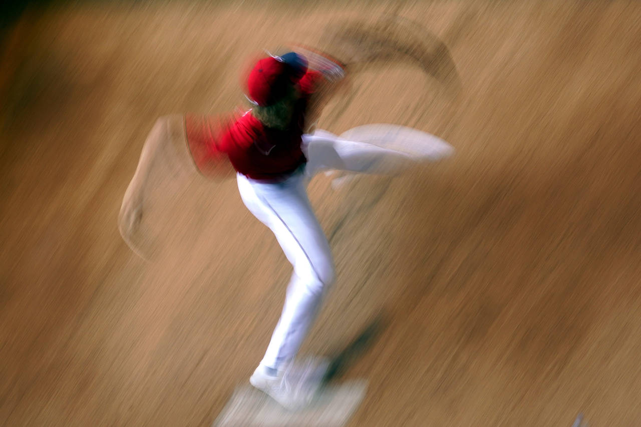 In this image taken with a slow shutter speed, Minnesota Twins starting pitcher Joe Ryan warms up i...