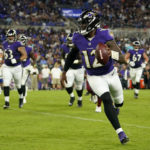 
              Baltimore Ravens quarterback Anthony Brown rushes for a touchdown in the second half of a preseason NFL football game against the Washington Commanders, Saturday, Aug. 27, 2022, in Baltimore. (AP Photo/Julio Cortez)
            