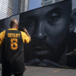 
              Erikk Aldridge records a mural depicting Kobe Bryant in Los Angeles, Wednesday, Aug. 24, 2022. The mural, painted by Odeith and Nikkolas Smith, was unveiled Wednesday to celebrate Kobe Bryant Day. (AP Photo/Jae C. Hong)
            