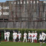 
              Chicago Cubs and Cincinnati Reds players walk onto the field before a baseball game at the Field of Dreams movie site, Thursday, Aug. 11, 2022, in Dyersville, Iowa. (AP Photo/Charlie Neibergall)
            