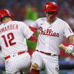
              Philadelphia Phillies' Kyle Schwarber, left, celebrates his home run with Rhys Hoskins, right, during the seventh inning of a baseball game against the Washington Nationals, Friday, Aug. 5, 2022, in Philadelphia. (AP Photo/Chris Szagola)
            