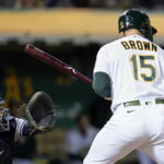 
              Oakland Athletics' Seth Brown (15) is hit by a pitch with the bases loaded during the seventh inning of a baseball game against the New York Yankees in Oakland, Calif., Thursday, Aug. 25, 2022. Skye Bolt scored on the play. (AP Photo/Godofredo A. Vásquez)
            