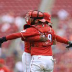 
              Cincinnati Reds' Alexis Diaz, right, hugs Austin Romine after the final out of a baseball game against the Chicago Cubs in Cincinnati, Sunday, Aug. 14, 2022. (AP Photo/Aaron Doster)
            