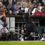
              Chicago White Sox's Josh Harrison, right, and Houston Astros catcher Martin Maldonado watch Harrison's inning-ending popup during the seventh inning of a baseball game Monday, Aug. 15, 2022, in Chicago. (AP Photo/Charles Rex Arbogast)
            