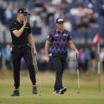 
              Justin Thomas of the US, left, and Viktor Hovland, of Norway, on the 3rd green during the first round of the British Open golf championship on the Old Course at St. Andrews, Scotland, Thursday, July 14 2022. The Open Championship returns to the home of golf on July 14-17, 2022, to celebrate the 150th edition of the sport's oldest championship, which dates to 1860 and was first played at St. Andrews in 1873. (AP Photo/Alastair Grant)
            